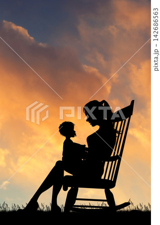 Mother and Child Silhouette at Sunset in Rocking Chair Mother and Child Silhouette at Sunset in Rocking Chair 142686563