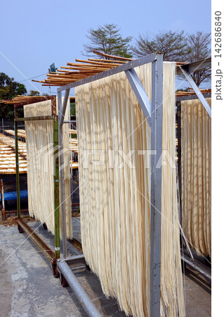 Traditional Noodles Drying on Outdoor Racks in Sunlight Traditional Noodles Drying on Outdoor Racks in Sunlight 142686840