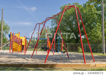 Empty Playground Swings on Sunny Day 142688572