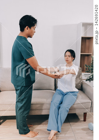 A Modern rehabilitation physiotherapy man at work with woman client 142691420