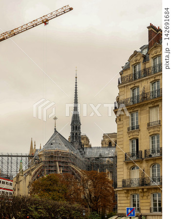Notre dame de paris cathedral undergoing extensive restoration with scaffolding and cranes, rebuilding the iconic structure in france Notre dame de paris cathedral undergoing extensive restoration with scaffolding and cranes, rebuilding the iconic structure in france 142691684
