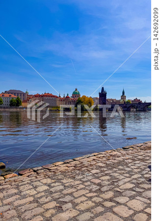 View of Charles Bridge in Prague on a clear day with reflections in the river View of Charles Bridge in Prague on a clear day with reflections in the river 142692099