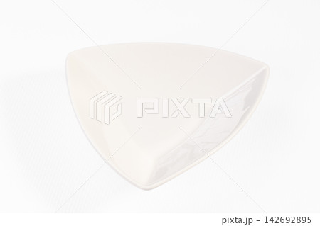 White triangular ceramic bowl on clean white background with soft shadow and glossy finish White triangular ceramic bowl on clean white background with soft shadow and glossy finish 142692895