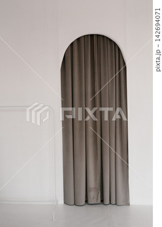 Minimalist Interior with Arched Doorway and Gray Curtains Minimalist Interior with Arched Doorway and Gray Curtains 142694071