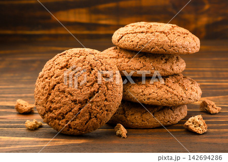 Oatmeal cookies close-up on a wooden background. Oatmeal cookies close-up on a wooden background. 142694286