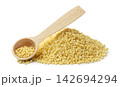 A pile of raw millet and a wooden spoon in close-up on a white background. Isolated 142694294