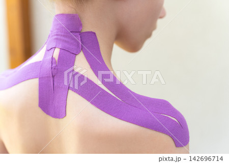 Closeup Of Kinesiology Tape On Neck And Shoulder From Side Against Light Background. Therapeutic Tape And Muscle Support Concept 142696714
