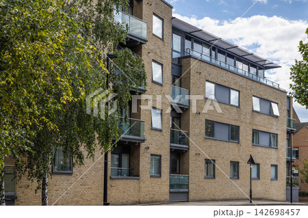 Contemporary residential block with glass balconies 142698457