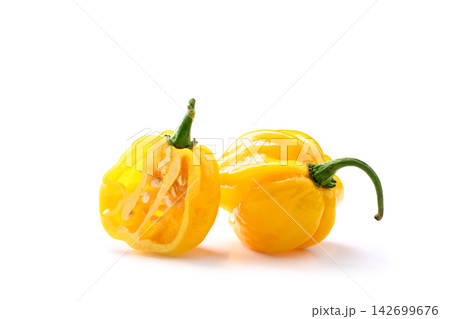 Two yellow habanero peppers one cut open 142699676