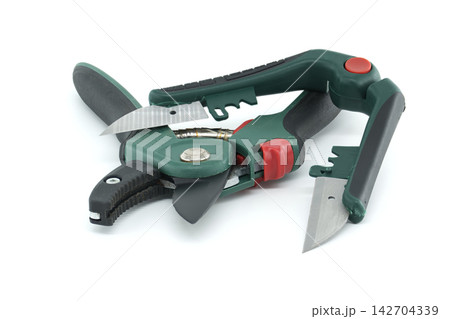Combined Multi-Function Pruning Shears and Folding Utility Knife Resting on a Clean Surface Combined Multi-Function Pruning Shears and Folding Utility Knife Resting on a Clean Surface 142704339