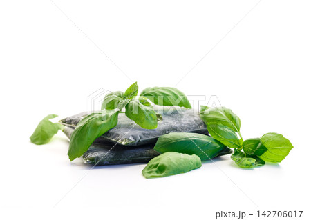 Frozen basil portions prepared for freezer storage on white background 142706017