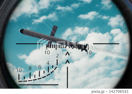 Guided missile seen through targeting scope against blue cloudy sky Guided missile seen through targeting scope against blue cloudy sky 142706581