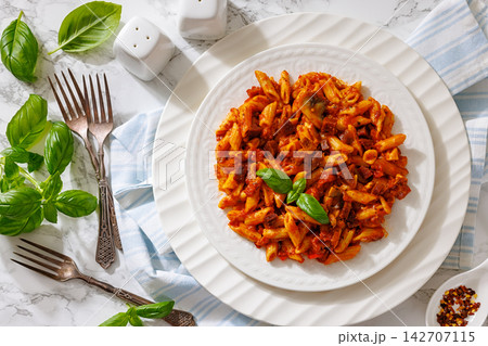 Penne alla salsiccia e funghi on a plate 142707115