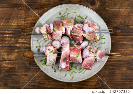 Traditional pork shashlik skewers with onion and herbs Traditional pork shashlik skewers with onion and herbs 142707389