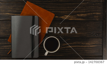 Coffee cup on a desk with notebooks and a calm workspace setup 142708367