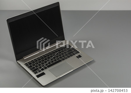 Laptop sits on a gray desk in a modern office setting during work hours Laptop sits on a gray desk in a modern office setting during work hours 142708453