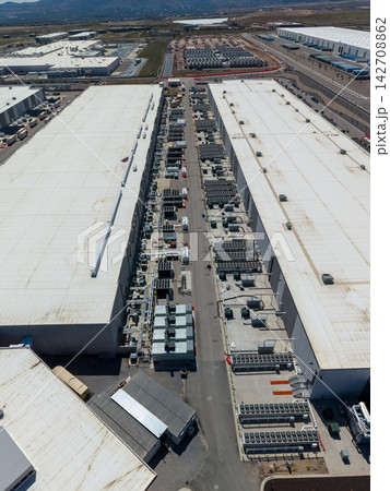 Aerial view of a massive data center facility and cooling systems Aerial view of a massive data center facility and cooling systems 142708862