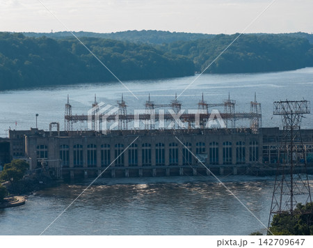 Large hydroelectric power station with electrical grid towers by water 142709647