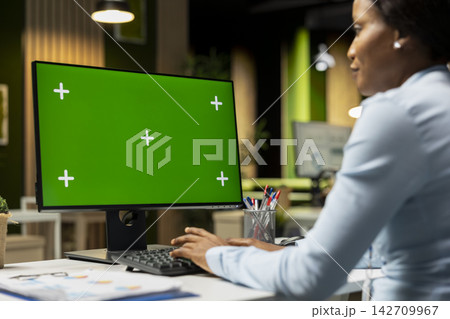 Green screen mockup next to woman business analyst reviewing forecasts, building a new development strategy to expand the company and boost performance metrics. Professional objectives. Green screen mockup next to woman business analyst reviewing forecasts, building a new development strategy to expand the company and boost performance metrics. Professional objectives. 142709967