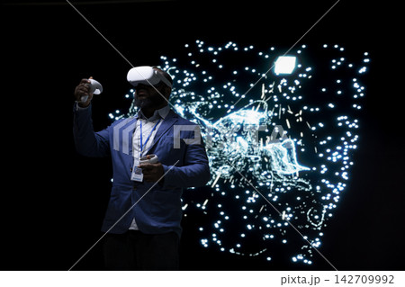 Programmer optimizing AI agent using virtual reality simulation, adjusting artificial neurons. Computer scientist uses VR headset gear to look at neural network architecture visualization Programmer optimizing AI agent using virtual reality simulation, adjusting artificial neurons. Computer scientist uses VR headset gear to look at neural network architecture visualization 142709992