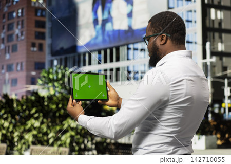 Horizontal chroma key screen with man walking around urban city center, metropolitan area with skyscrapers and busy streets. Black adult going for a stroll downtown, urbanism. Horizontal chroma key screen with man walking around urban city center, metropolitan area with skyscrapers and busy streets. Black adult going for a stroll downtown, urbanism. 142710055