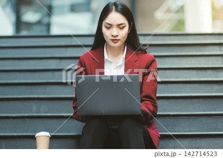 Asian woman in sitting at stairway outdoor have a stressed, after being laid off unemployed. Desperate be out of work. Asian woman in sitting at stairway outdoor have a stressed, after being laid off unemployed. Desperate be out of work. 142714523