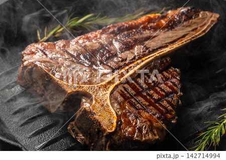 Smoky Grilled T Bone Steak in Cast Iron Pan Smoky Grilled T Bone Steak in Cast Iron Pan 142714994
