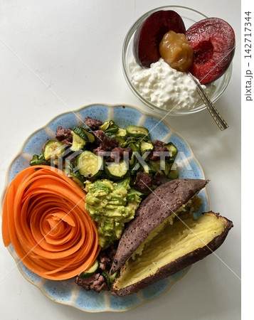 Fresh salad with a mix of crisp leafy greens, sliced vegetables, and colorful ingredients, tossed together to create a healthy, vibrant, and refreshing dish full of natural flavors 142717344