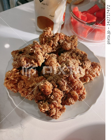 Crispy Korean fried chicken, perfectly glazed with a sweet and spicy sauce. Ideal for food photography and menus, showcasing the irresistible crunch and flavor of this beloved dish. Crispy Korean fried chicken, perfectly glazed with a sweet and spicy sauce. Ideal for food photography and menus, showcasing the irresistible crunch and flavor of this beloved dish. 142717472