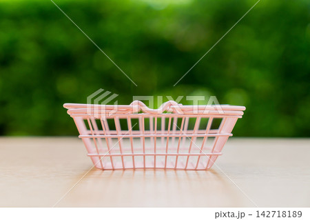small basket on green grass small basket on green grass 142718189
