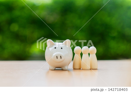 Piggy bank on table with green nature background, Save money for prepare retirement concept. 142718403