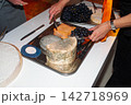 Guests Serving Aged Cheese and Grapes on a Silver Platter at a Party Buffet 142718969