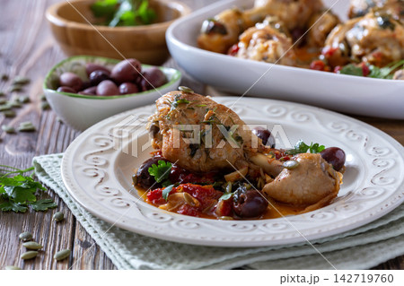 Roasted Chicken with Olives and Tomatoes. Roasted Chicken with Olives and Tomatoes. 142719760