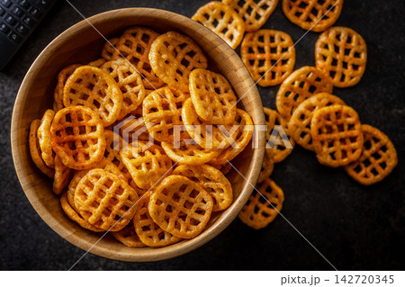 Crispy Waffle Snacks in Wooden Bowl With Seasoned Cheese Flavor for Movie Night Crispy Waffle Snacks in Wooden Bowl With Seasoned Cheese Flavor for Movie Night 142720345