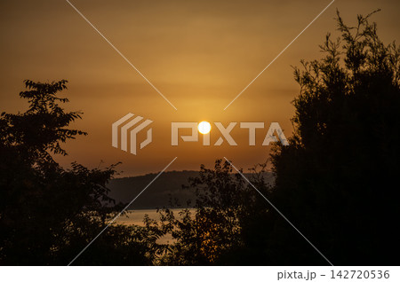 Wonderful sunset casting warm golden and orange hues over the charming village of Salvatierra de Tormes, Spain 142720536
