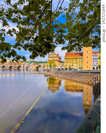 Prague riverside view with Charles Bridge and buildings in background 142721844