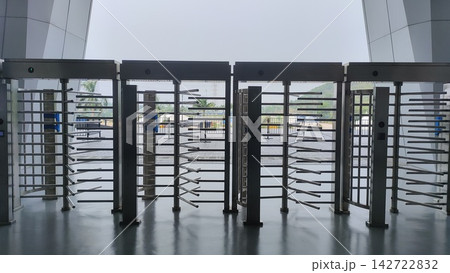 Row of stainless steel full-height security turnstiles at modern stadium entrance Row of stainless steel full-height security turnstiles at modern stadium entrance 142722832