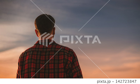 Back View of Man Looking at Sunset Sky Back View of Man Looking at Sunset Sky 142723847