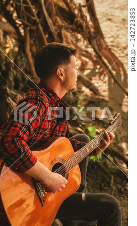 Musician Playing Acoustic Guitar under Tree Musician Playing Acoustic Guitar under Tree 142723853