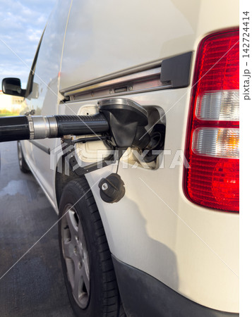 Close-up of a fuel nozzle refueling a car at a gas station, illustrating fuel prices, rising transportation costs, inflation, energy expenses and household budgets. Close-up of a fuel nozzle refueling a car at a gas station, illustrating fuel prices, rising transportation costs, inflation, energy expenses and household budgets. 142724414