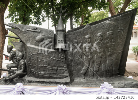 The Seri Thai (Free Thai Movement) Memorial monument at Thammasat University, depicting historic resistance forces and the iconic campus Dome Building spire in dark bronze relief. The Seri Thai (Free Thai Movement) Memorial monument at Thammasat University, depicting historic resistance forces and the iconic campus Dome Building spire in dark bronze relief. 142725416