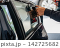 A car wrapping specialist applies a polyurethane film to the car. Detailer PPF 142725682