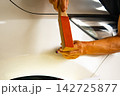 Removing dents on the car. PDR technology. Car body repair without painting. 142725877