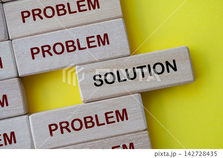 Top view of solution text on wooden block with representing solution to problems 142728435
