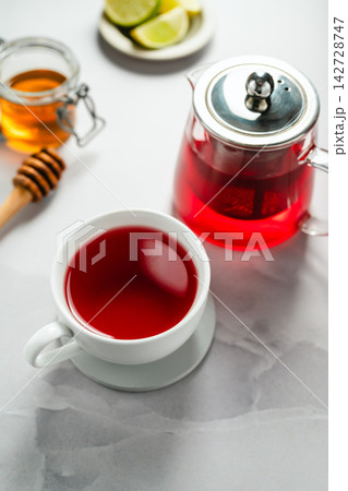 Warm berry tea with honey, lemon and lime, cozy autumnal drink 142728747