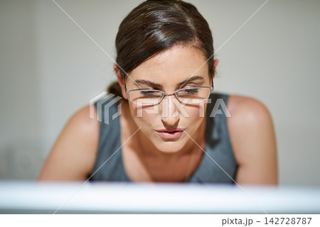 Computer, face and remote work with freelance woman in home office for information or research. Glasses, reading and small business startup with employee in apartment for email, planning or update Computer, face and remote work with freelance woman in home office for information or research. Glasses, reading and small business startup with employee in apartment for email, planning or update 142728787
