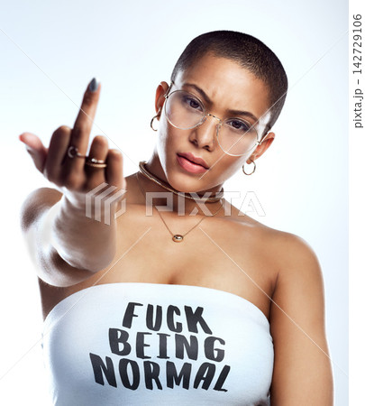 Anger, portrait and woman in studio with middle finger for empowerment, rebel opinion and feminist advocacy. Female person, protest and rude emoji or sign for feedback to conflict by white background Anger, portrait and woman in studio with middle finger for empowerment, rebel opinion and feminist advocacy. Female person, protest and rude emoji or sign for feedback to conflict by white background 142729106
