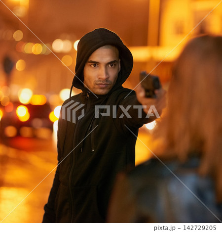 Robber, night and man gun with criminal, victim or thief pointing weapon for armed assault or mugging. Threat, law breaking and serious gangster with violence, hoodie or pistol for danger in city Robber, night and man gun with criminal, victim or thief pointing weapon for armed assault or mugging. Threat, law breaking and serious gangster with violence, hoodie or pistol for danger in city 142729205