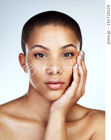 Beauty, portrait and skin of natural black woman in studio on blue background for aesthetic wellness. Cosmetics, face and skincare with confident model for dermatology, foundation or vitamin c Beauty, portrait and skin of natural black woman in studio on blue background for aesthetic wellness. Cosmetics, face and skincare with confident model for dermatology, foundation or vitamin c 142729220