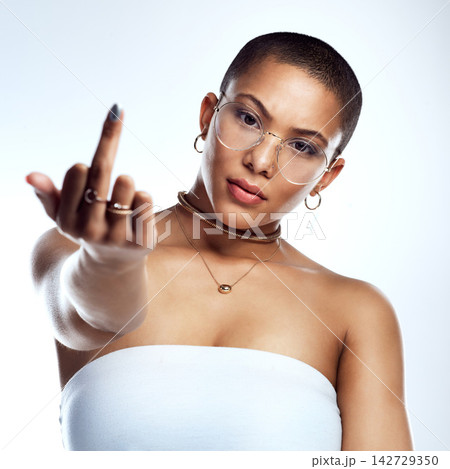 Angry, portrait and woman in studio with middle finger for empowerment, rebel opinion and feminist advocacy. Female person, protest and rude emoji or icon for feedback to conflict by white background Angry, portrait and woman in studio with middle finger for empowerment, rebel opinion and feminist advocacy. Female person, protest and rude emoji or icon for feedback to conflict by white background 142729350